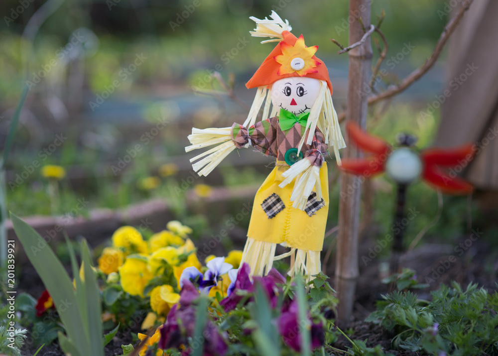 Scarecrow on a flower bed Scarecrow on a flower bed