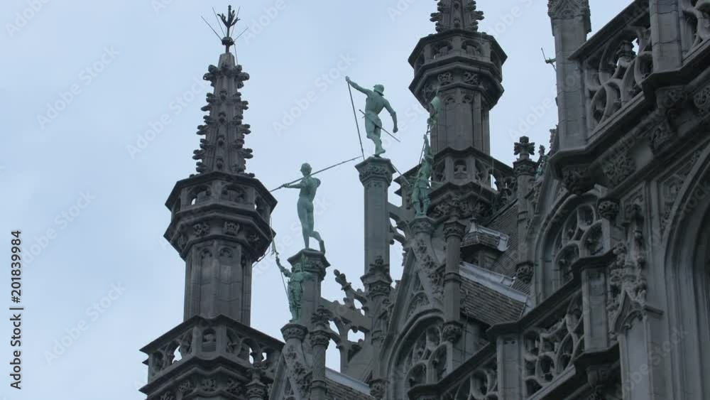A building top with statues and turrets A building top with statues and turrets