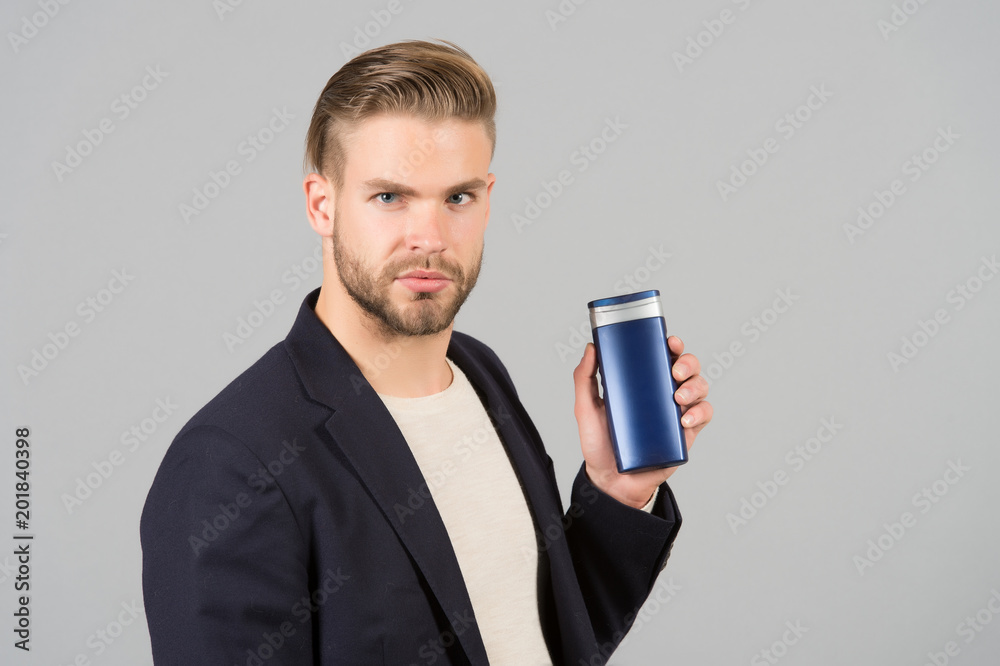 Manager with shampoo or gel bottle in hand. Bearded man with stylish hair or haircut. Cosmetic for spa bath or shower. Hair care and beard grooming. Mens beauty and health