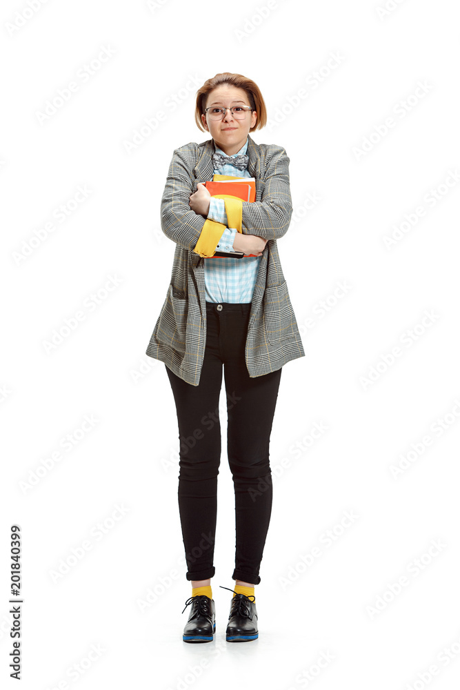 Full length portrait of a happy smiling female student holding books isolated on white background Full length portrait of a happy smiling female student holding books isolated on white background