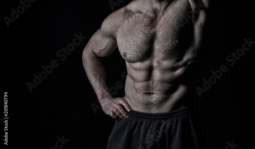 Arm with strong biceps and triceps. Torso with six pack and ab muscles. Athletic belly and muscular chest. Workout and training activity in gym. Sport fitness and wellness concept, vintage