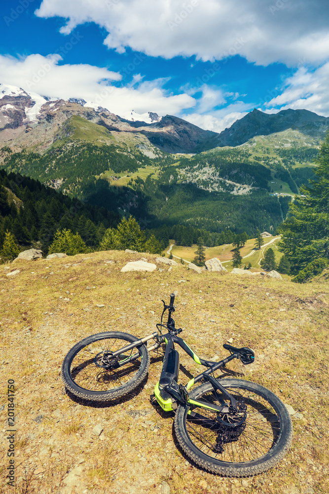 Fat bike on the grass and beautiful italian mountainscape