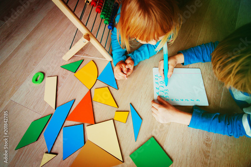 little boy and girl learn to write and calculate numbers