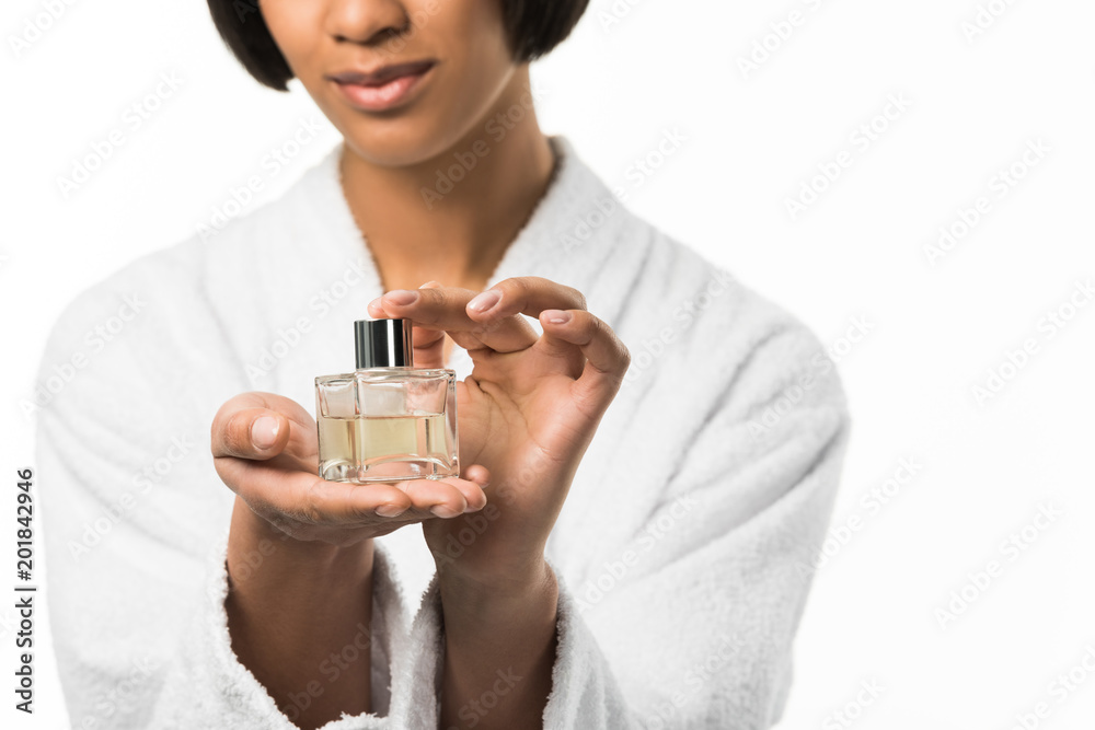 cropped view of african american girl holding bottle, isolated on white cropped view of african american girl holding bottle, isolated on white