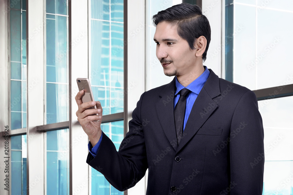 Handsome asian businessman using smartphone Handsome asian businessman using smartphone
