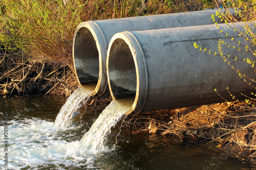 Discharge of sewage into a river photo