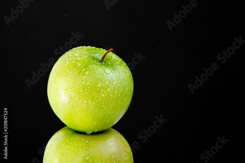 pyramid of two fresh juicy wet apples on black background