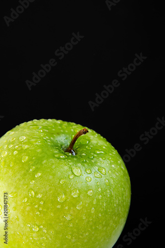 top of green wet fresh Apple on black background