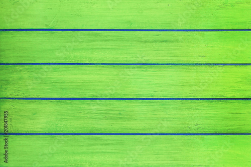 Green wooden planks background close up.