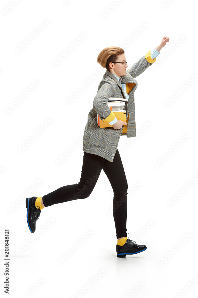 Full length portrait of a happy smiling female student holding books isolated on white background Full length portrait of a happy smiling female student holding books isolated on white background