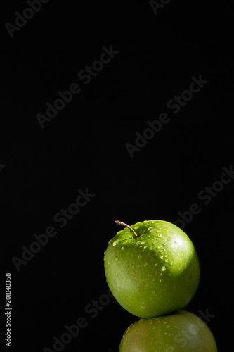 pyramid of two fresh juicy wet apples on black background