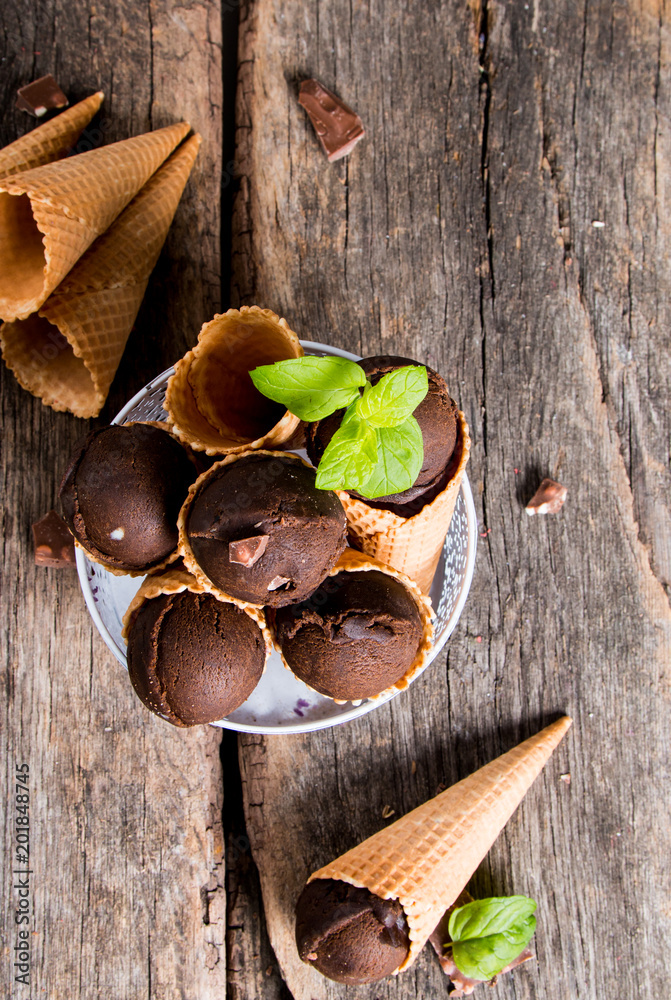 Ice cream, Chocolate scoop ice cream in cone on wooden table. 