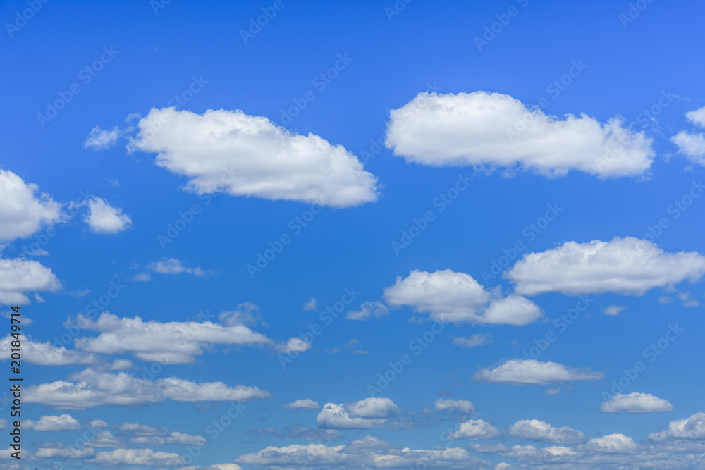 White fluffy clouds in a deep blue sky White fluffy clouds in a deep blue sky