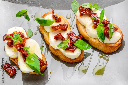Fényképezés Tasty savory Italian appetizers, or bruschetta, on slices of toasted baguette ga