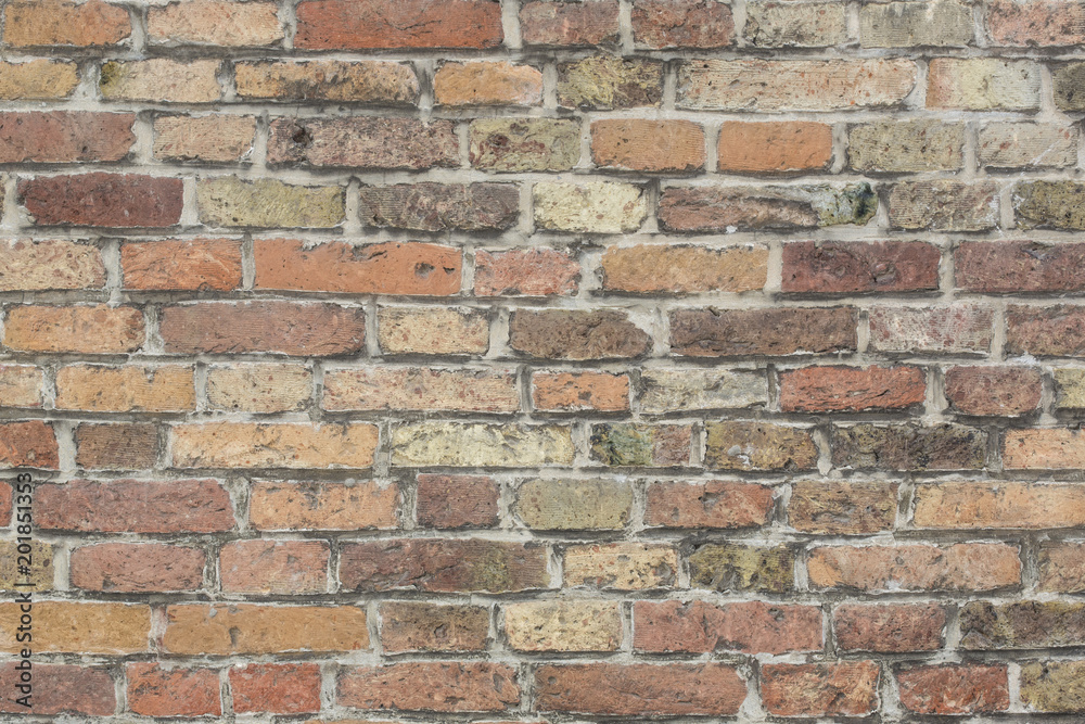 Wall made from red and sometimes colorful bricks of regular shapes and random distribution slotting together precisely. Close up architecture photography. Creative wallpaper photography. Wall made from red and sometimes colorful bricks of regular shapes and random distribution slotting together precisely. Close up architecture photography. Creative wallpaper photography.