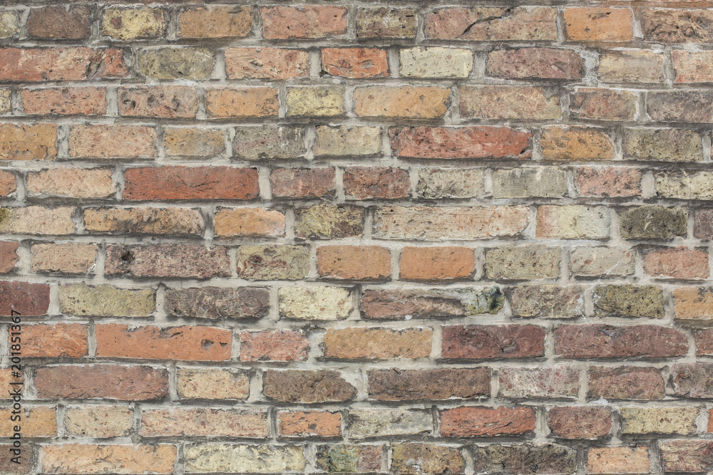 Wall made from red and sometimes colorful bricks of regular shapes and random distribution slotting together precisely. Close up architecture photography. Creative wallpaper photography. Wall made from red and sometimes colorful bricks of regular shapes and random distribution slotting together precisely. Close up architecture photography. Creative wallpaper photography.