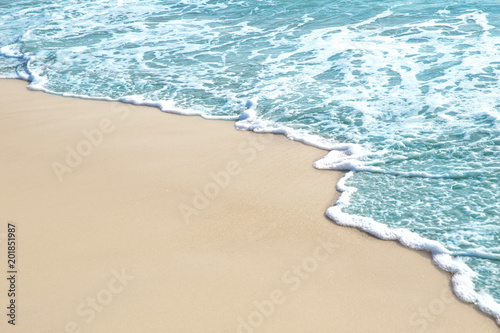 Soft wave and sea bubble of blue sea on sandy beach