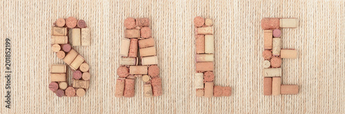 Word SALE made of wine corks on sea ropes background. Banner
