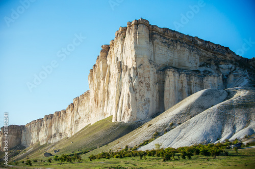 View of White rock or Aq Qaya on a Sunny summer day. Crimea. White limestone with a vertical cliff