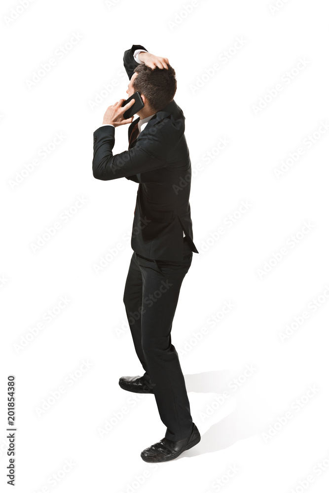 Thee profile portrait of a businessman with very serious face. Confident professional with mobile phone Thee profile portrait of a businessman with very serious face. Confident professional with mobile phone