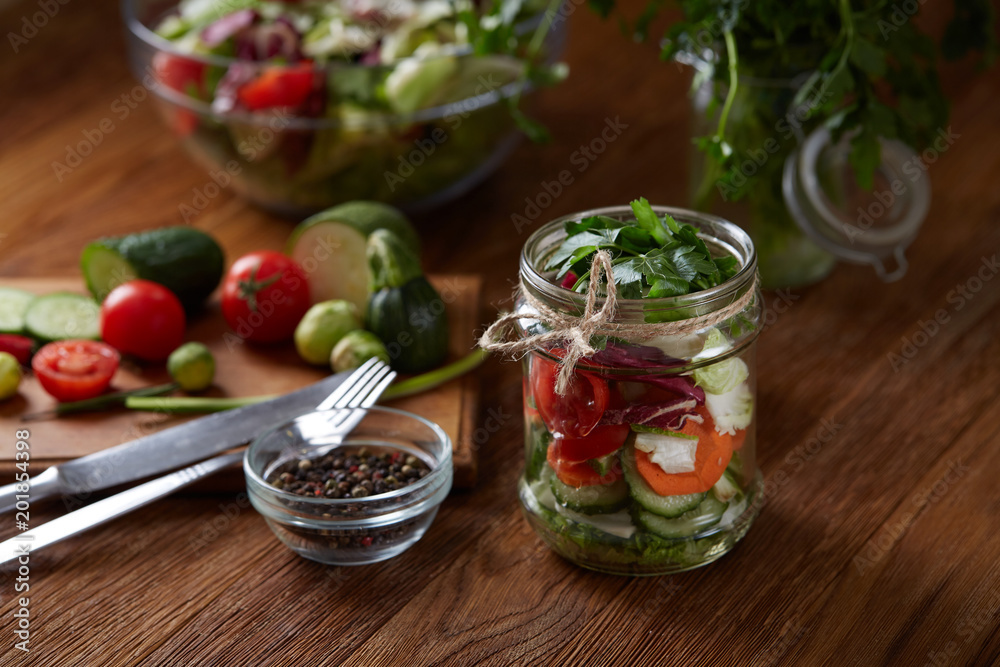 Fresh vegetable salad and ripe veggies on cutting board over wooden background, close up, selective focus Fresh vegetable salad and ripe veggies on cutting board over wooden background, close up, selective focus