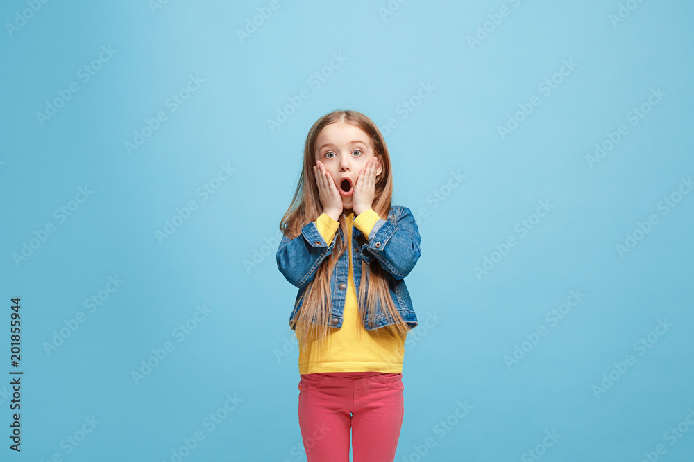 Beautiful teen girl looking suprised isolated on blue Beautiful teen girl looking suprised isolated on blue