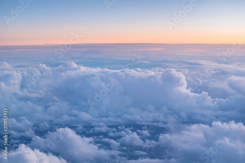 Beautiful sunset with cloudy sky from the airplane window. © Lukas Gojda