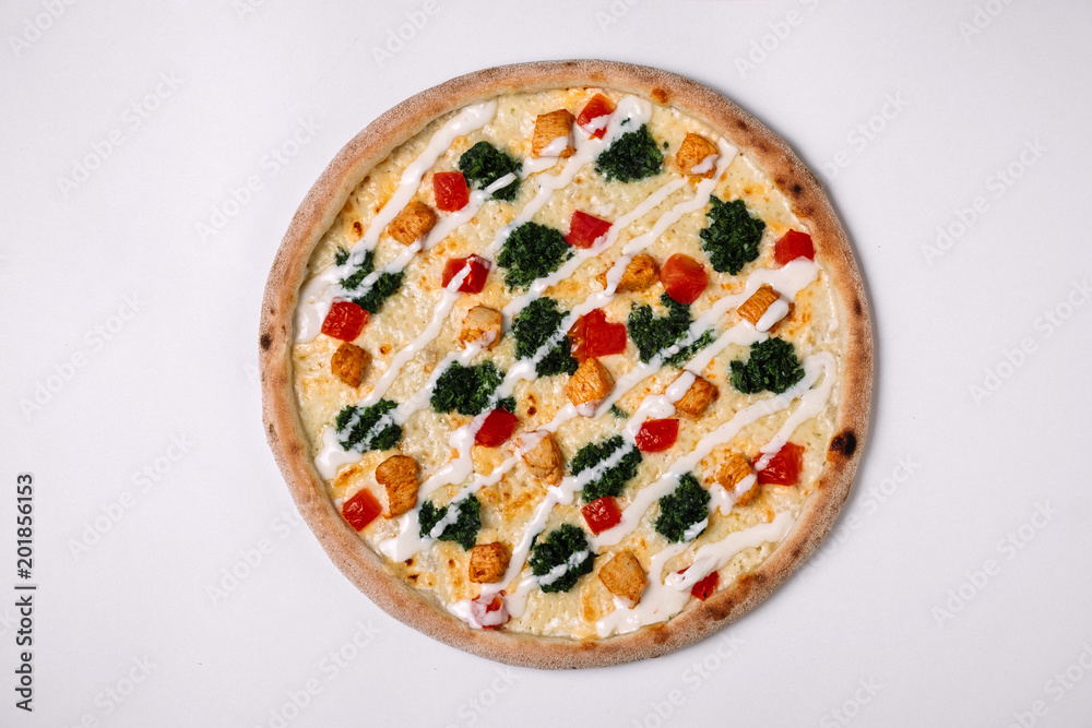 Pizza with chicken, tomato and spinach on white. Top view Pizza with chicken, tomato and spinach on white. Top view