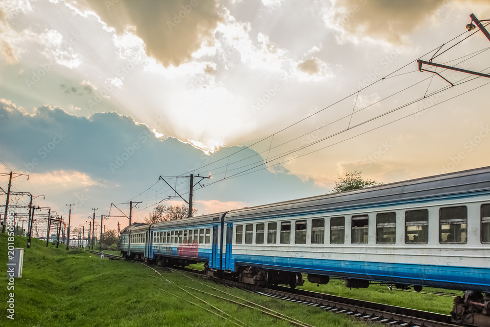 Railroad train in trip time on country side landscape in poor industrial environment 