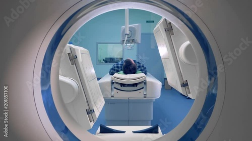 A man gets a scan in a hospital room. photo