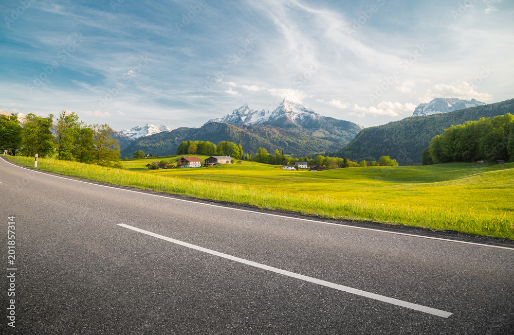 Empty asphalt country road with alpine mountain scenery in summer