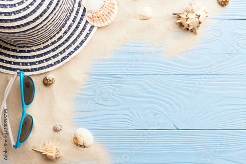 Marine concept. Beach accessories, sand and seashells on blue wooden table