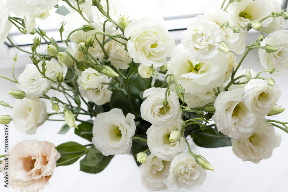 bouquet of white flowers in a vase. Eustoma bouquet of white flowers in a vase. Eustoma