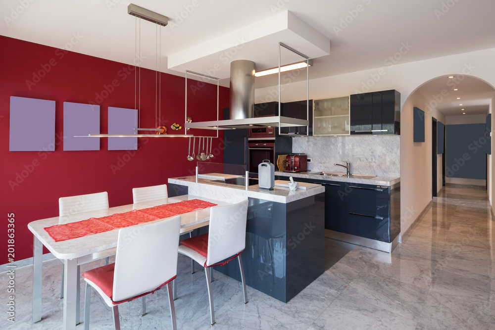 Modern kitchen with island, marble table and leather chairs Modern kitchen with island, marble table and leather chairs
