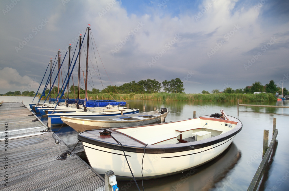 yachts and boats at pier on lake yachts and boats at pier on lake