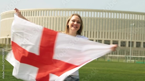 Woman with the flag of England. Woman football fan with English flag. photo