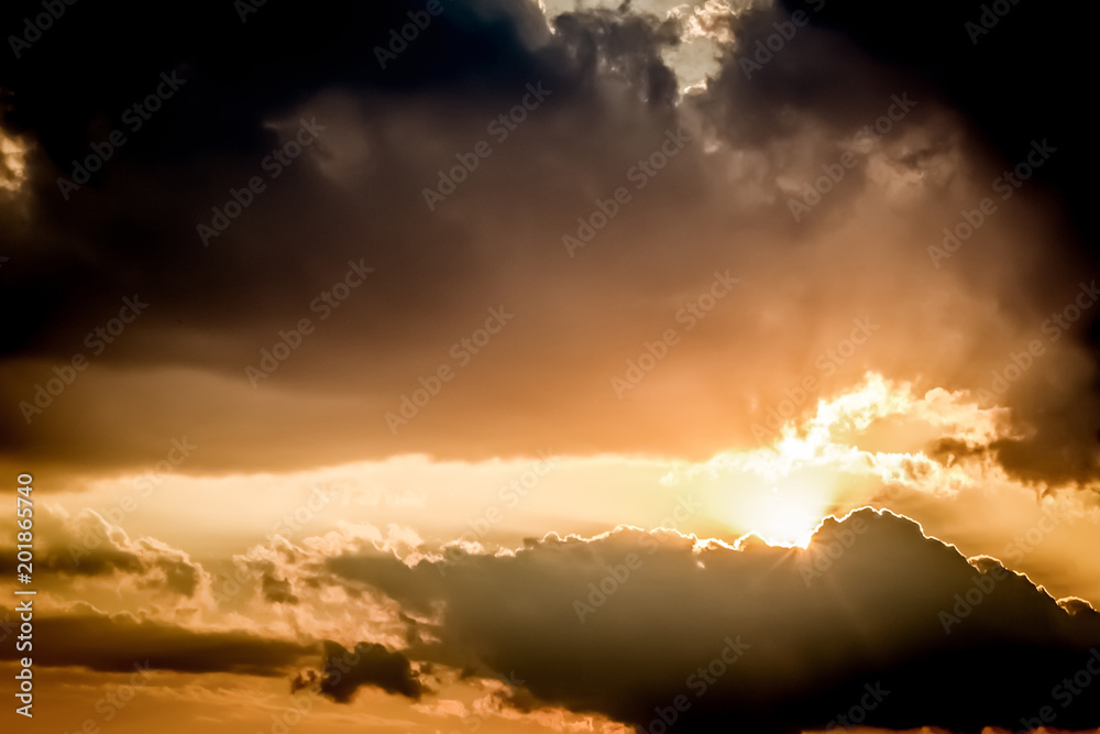 Fototapeta premium Dramatic evening sunset sky concept with sun rays clouds and empty space for copy or text