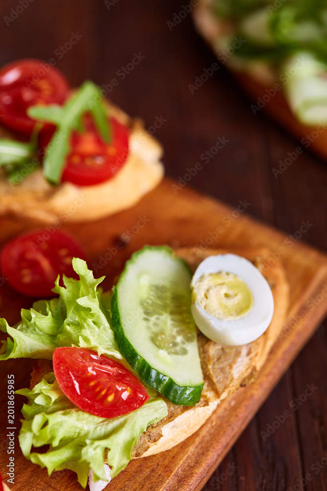 Breakfast still life with sandwiches, quail eggs, spicies and fresh fruits and vegetables, selective focus