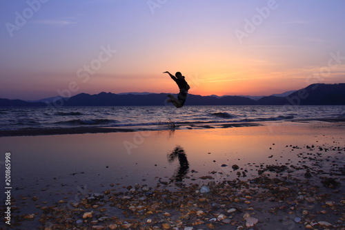 夕日　ジャンプしている人　シルエット　絶景 © amosfal