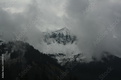 cold misty, foggy clouds on the mountains in the alps in Switzerland, Europe