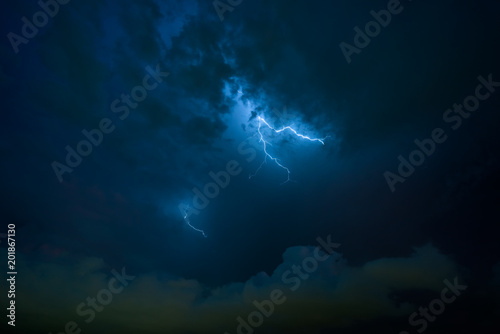 Stroke of lightning with storm clouds