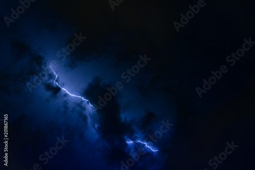 Stroke of lightning with storm clouds