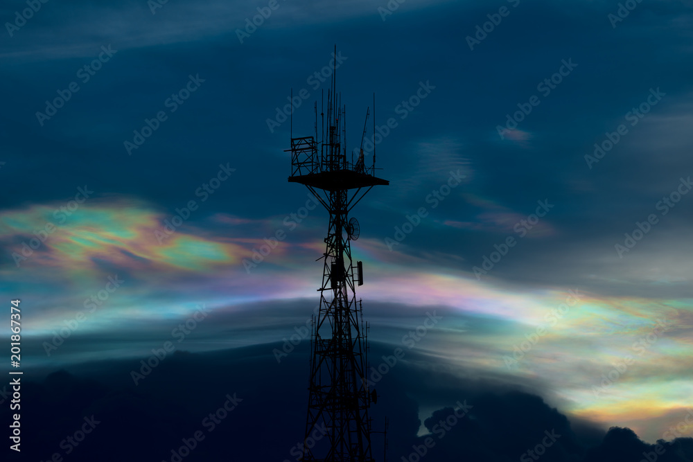 Silhouette of cellular tower with beautiful sunset cloudy sky