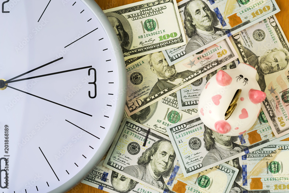 Clock, dollars and piggy bank. Concept time is money. View from above. Business, finance. Clock, dollars and piggy bank. Concept time is money. View from above. Business, finance.