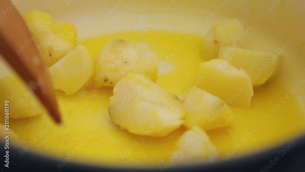 Sauteeing sweet potatoes on oil. The shot is in close up. Sauteeing sweet potatoes on oil. The shot is in close up.