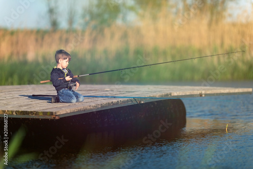 Young boy fishing on the pier