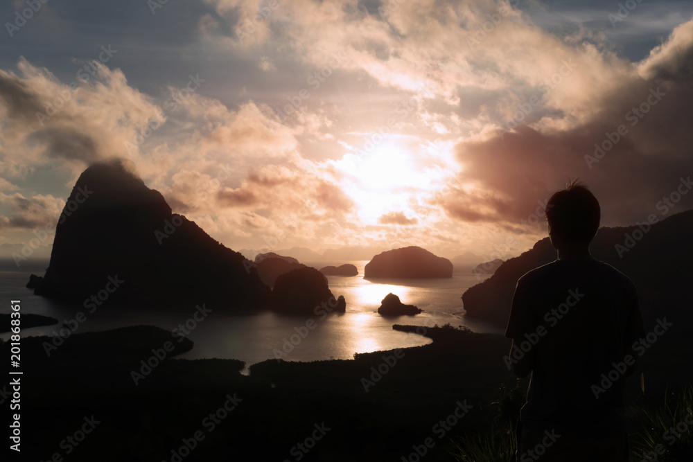 Man silhouette stay on mountain, sea and mountain with sunrise background. Satisfy hiker enjoy view.