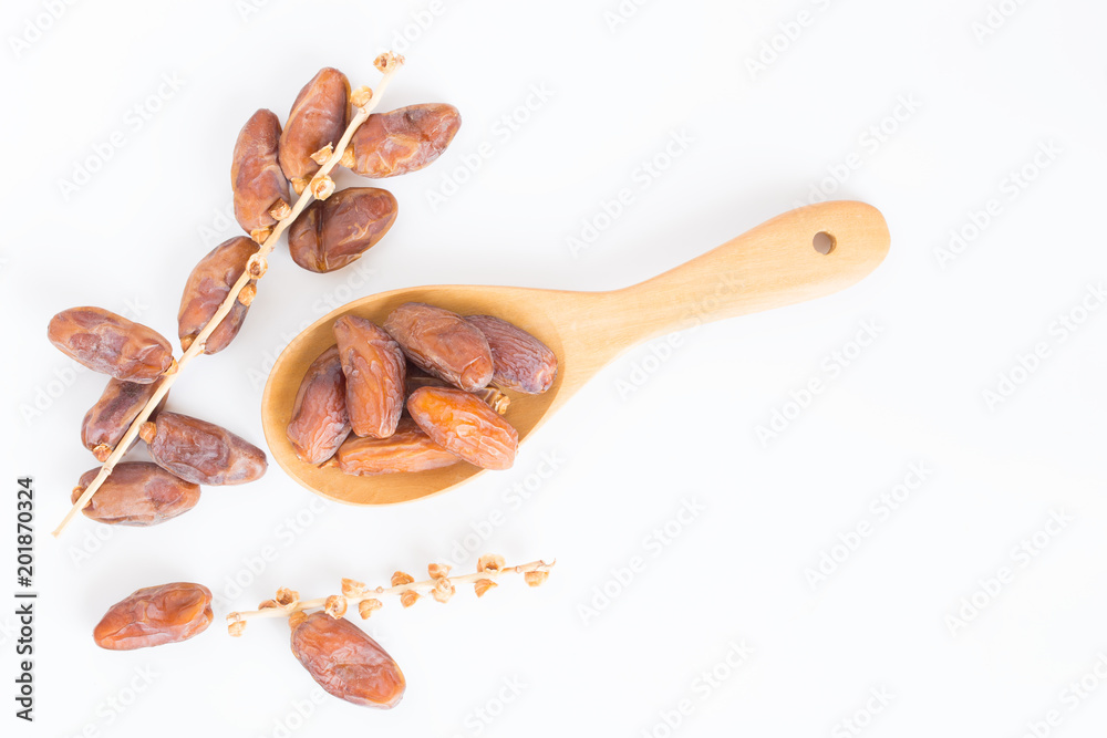 Dates fruit in wooden ladle on white background,Dried date palm fruits top view Dates fruit in wooden ladle on white background,Dried date palm fruits top view
