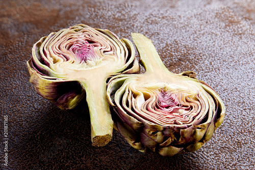 artichoke cut in half ob dark background