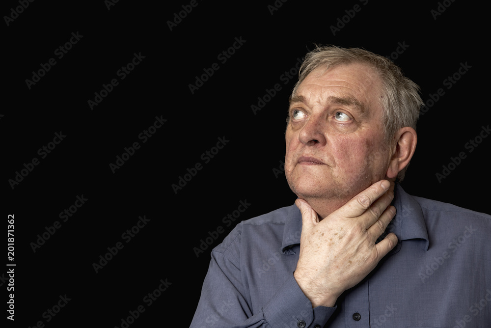 Portrait image of a mature Caucasian man looking upset and worried, on a black background Portrait image of a mature Caucasian man looking upset and worried, on a black background